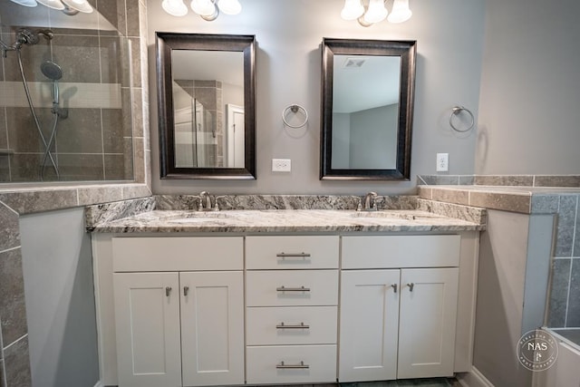 bathroom featuring vanity and a shower with door