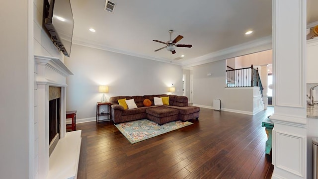 living room with dark hardwood / wood-style floors, ceiling fan, and crown molding