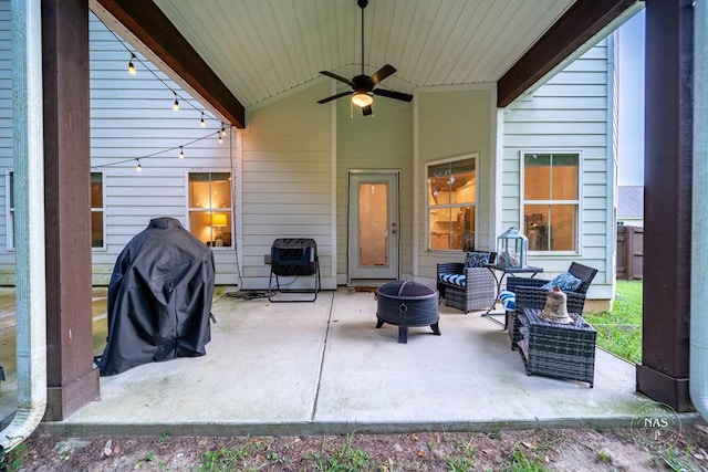 view of patio featuring heating unit, ceiling fan, and an outdoor living space with a fire pit