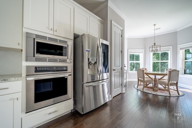 kitchen with decorative backsplash, appliances with stainless steel finishes, ornamental molding, dark hardwood / wood-style floors, and white cabinetry