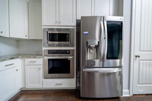 kitchen with backsplash, light stone counters, dark hardwood / wood-style flooring, white cabinetry, and stainless steel appliances