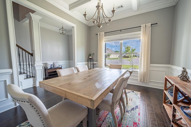 dining area featuring ornate columns, dark wood-type flooring, an inviting chandelier, beamed ceiling, and ornamental molding