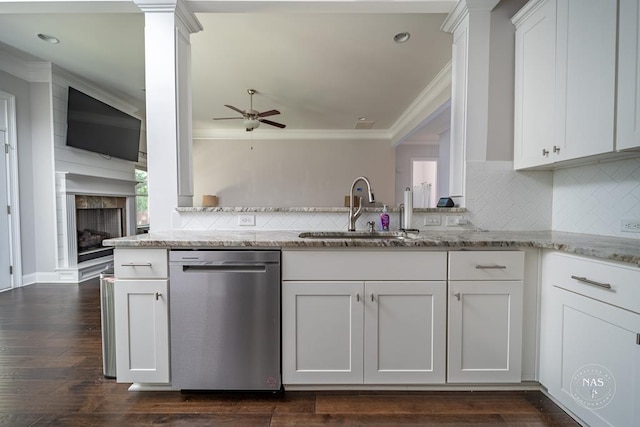 kitchen with white cabinetry, dishwasher, sink, light stone counters, and dark hardwood / wood-style flooring