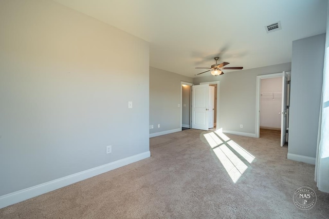 unfurnished room featuring ceiling fan and light colored carpet