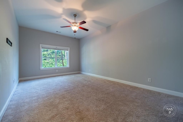 carpeted spare room featuring ceiling fan