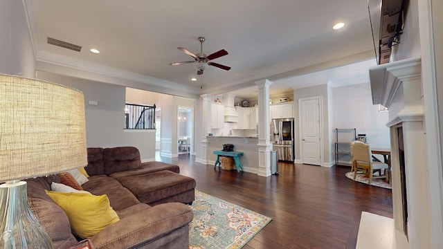 living room featuring ceiling fan, ornamental molding, and dark wood-type flooring