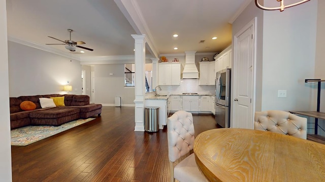 kitchen with dark hardwood / wood-style flooring, stainless steel fridge, decorative backsplash, custom range hood, and ornamental molding