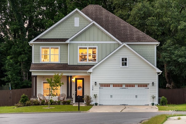 craftsman-style home featuring a garage and a front lawn