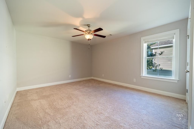 spare room with light colored carpet and ceiling fan