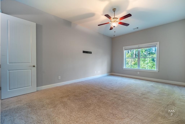 carpeted spare room featuring ceiling fan