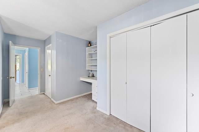 1303 Highland Dr, Elba, AL 36323 - unfurnished bedroom with light colored carpet, a closet, and a textured ceiling
