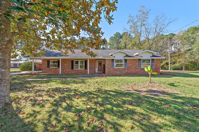 1303 Highland Dr, Elba, AL 36323 - single story home featuring brick siding, a front lawn, and board and batten siding