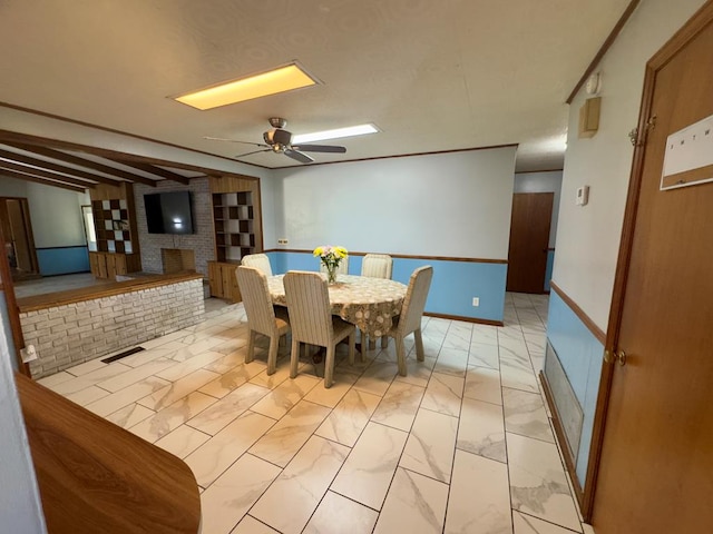 1303 Highland Dr, Elba, AL 36323 - dining space featuring light marble finish floors, a skylight, and ceiling fan