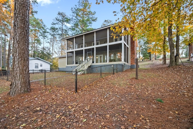 back of property featuring a sunroom