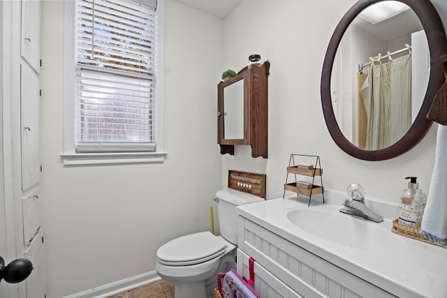 bathroom featuring tile patterned flooring, vanity, and toilet