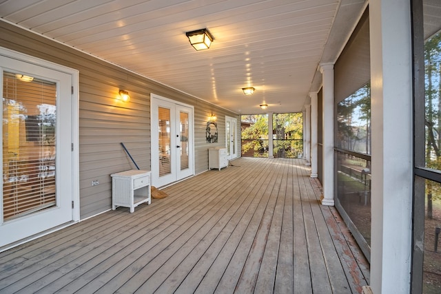 wooden deck with french doors and a porch