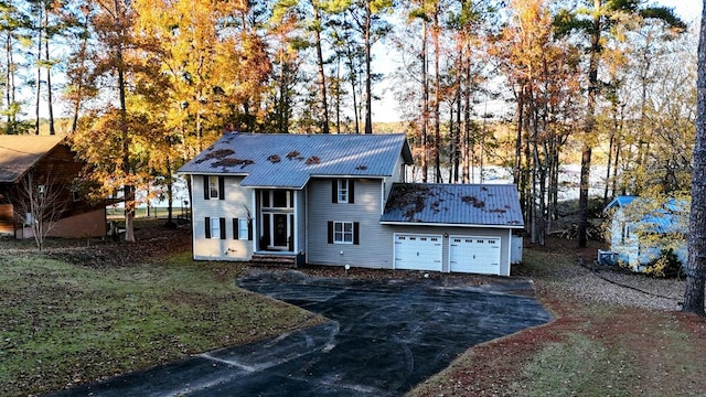 view of front of home featuring a garage and a front lawn