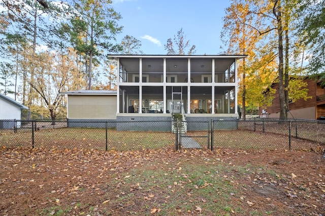 back of property with a sunroom