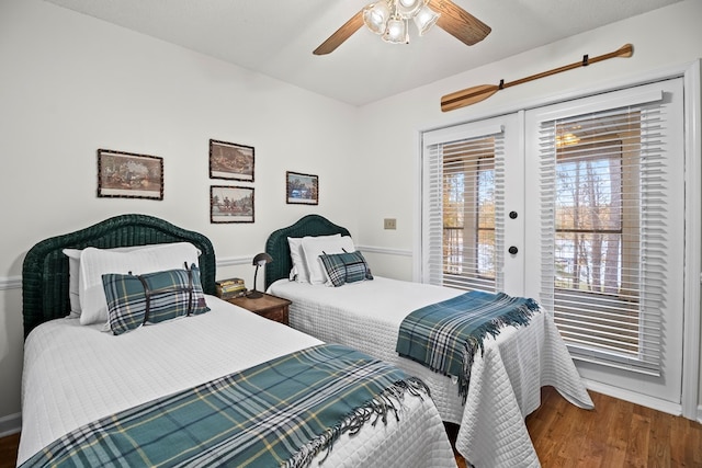 bedroom with access to exterior, ceiling fan, french doors, and dark wood-type flooring