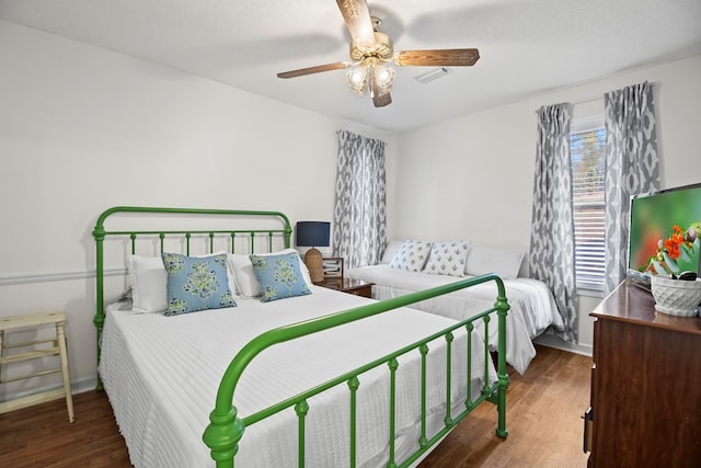 bedroom featuring a textured ceiling, dark hardwood / wood-style flooring, and ceiling fan