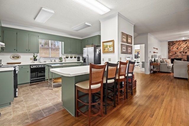 kitchen featuring green cabinetry, stainless steel fridge with ice dispenser, and light hardwood / wood-style flooring