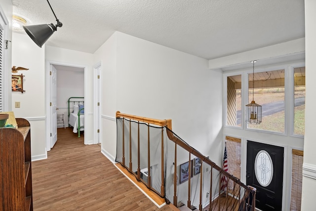 entrance foyer featuring wood-type flooring and a textured ceiling