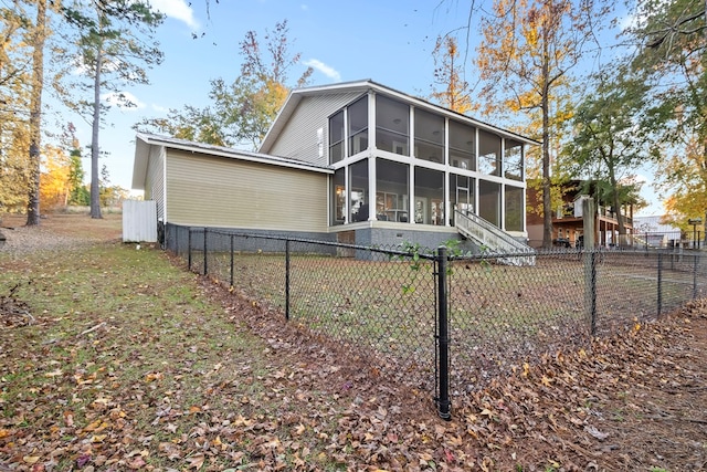 back of house featuring a sunroom