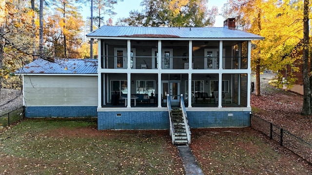 rear view of house with a balcony and a sunroom