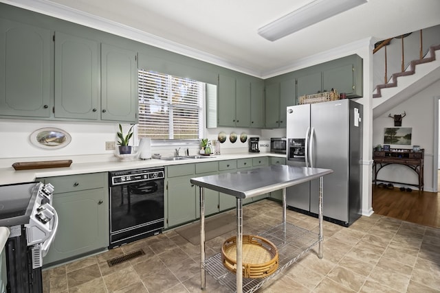 kitchen with green cabinets, sink, ornamental molding, and appliances with stainless steel finishes