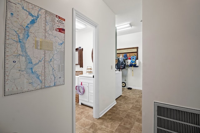 hall featuring a textured ceiling