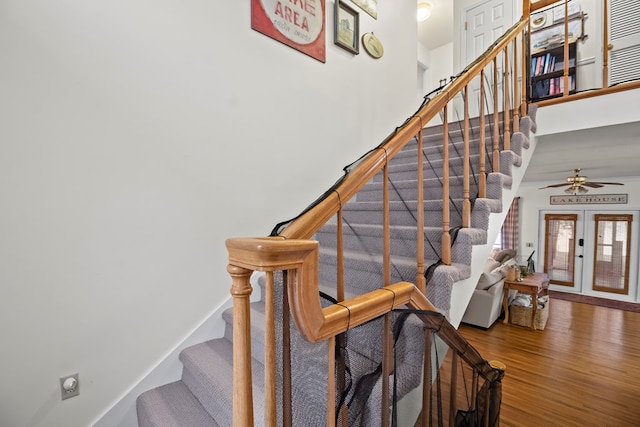 stairway featuring hardwood / wood-style floors, french doors, and ceiling fan