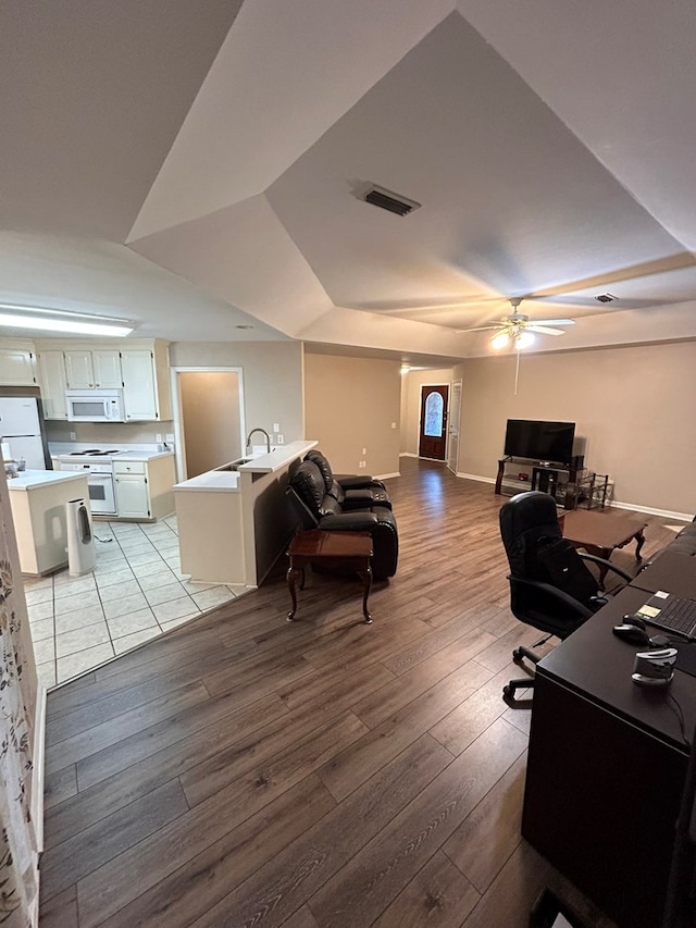 office featuring ceiling fan, light hardwood / wood-style flooring, and sink