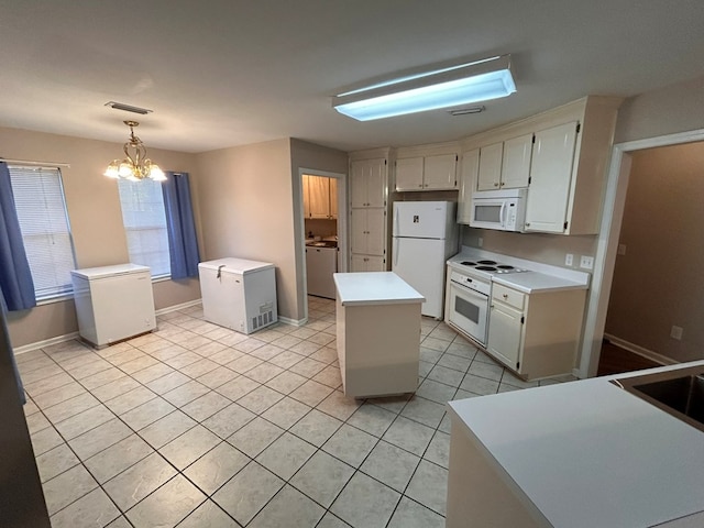 kitchen featuring pendant lighting, white appliances, light tile patterned floors, a notable chandelier, and a kitchen island