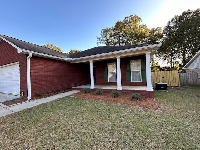 ranch-style house with covered porch, a garage, and a front lawn