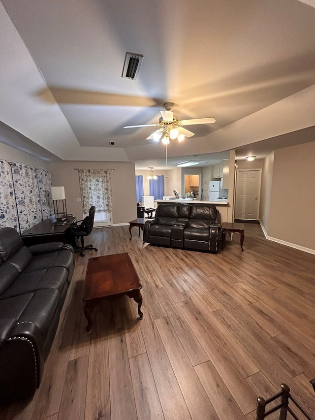 living room with ceiling fan and hardwood / wood-style flooring