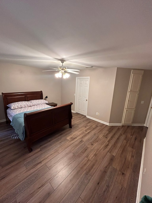 bedroom with ceiling fan and dark hardwood / wood-style floors