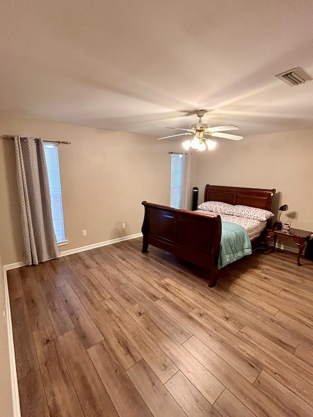 bedroom with ceiling fan and light hardwood / wood-style floors