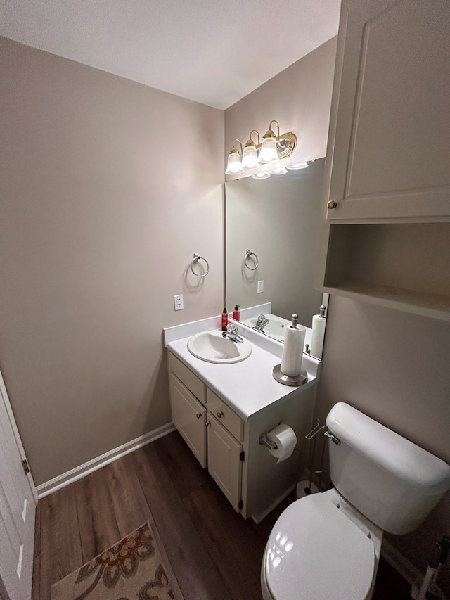 bathroom with vanity, toilet, and wood-type flooring