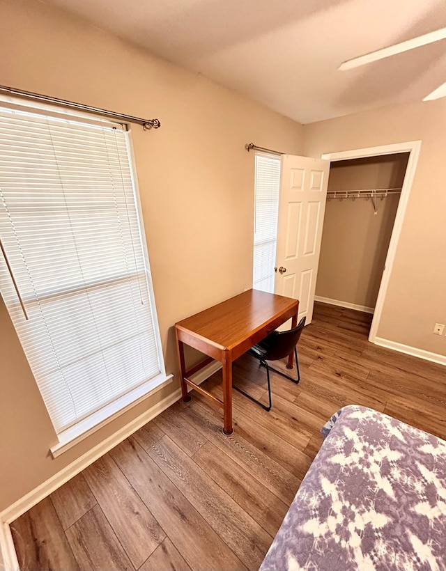 bedroom with wood-type flooring and a closet