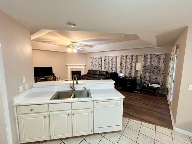 kitchen with dishwasher, white cabinets, sink, light hardwood / wood-style flooring, and ceiling fan