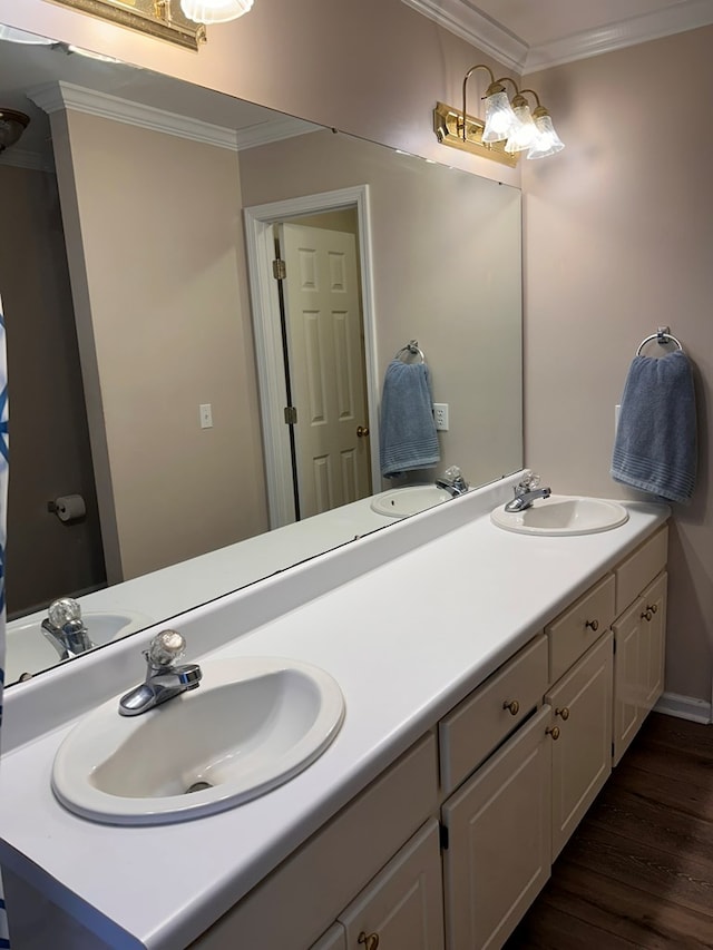 bathroom with hardwood / wood-style flooring, vanity, and ornamental molding