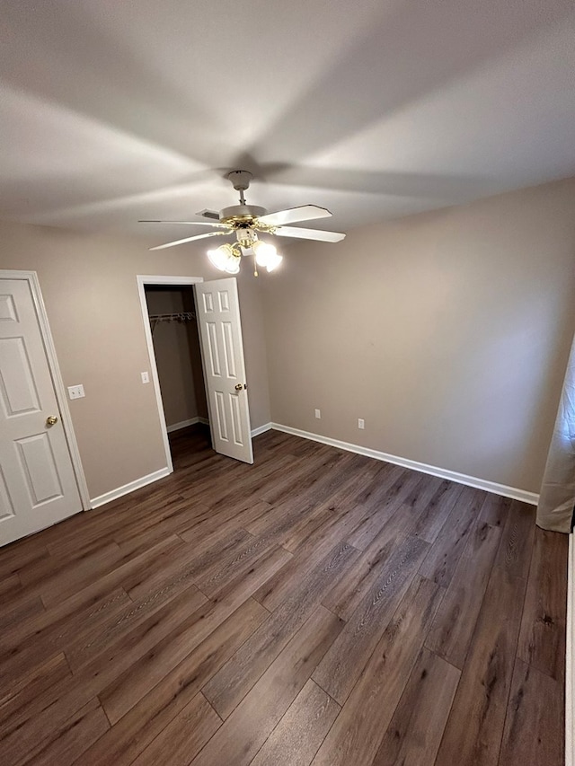 unfurnished bedroom with ceiling fan and dark hardwood / wood-style floors