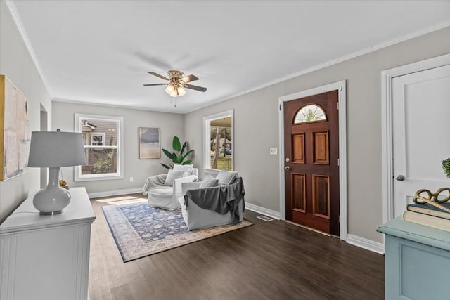 1301 S Bell St, Dothan, AL 36301 - foyer featuring dark wood-style floors, ceiling fan, baseboards, and crown molding