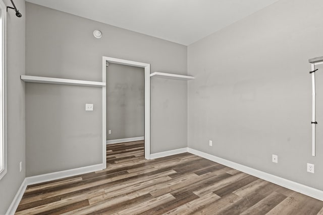 unfurnished bedroom featuring wood finished floors and baseboards