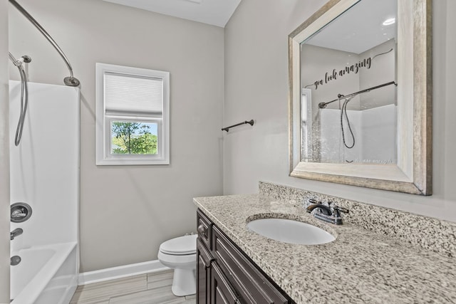 bathroom featuring baseboards, toilet, vanity, and shower / bathing tub combination