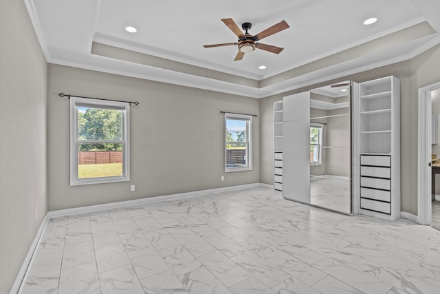 unfurnished bedroom featuring marble finish floor, baseboards, and multiple windows