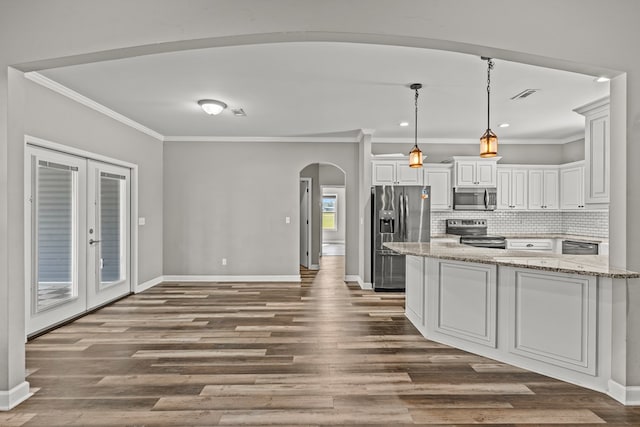 kitchen with visible vents, arched walkways, appliances with stainless steel finishes, and crown molding