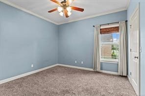 spare room with baseboards, ceiling fan, carpet, and crown molding