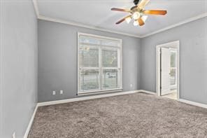 carpeted empty room with crown molding, plenty of natural light, baseboards, and a ceiling fan