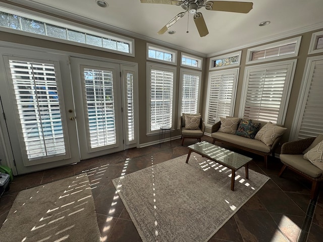 living area featuring ceiling fan, crown molding, and tile patterned flooring